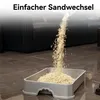 Cat litter being poured into a litter box in a living room setting. Produktbild-Vorschau