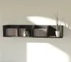 A black wall shelf with four compartments, holding CDs and a potted plant. Náhľad obrázku produktu