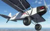 A biplane flying in the sky. Anteprima dell’immagine prodotto