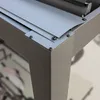 Close-up of the corner joint of a gray metal pergola leg and frame, showing screws and construction details. Voir les images du produit