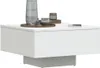 A modern white coffee table with decorative items on top. Voir les images du produit