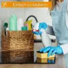 A person in an apron cleaning a kitchen surface with a spray bottle and a sponge. Náhľad obrázku produktu