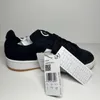 A single black Adidas Campus 00S J sneaker with white accents and a gum sole, shown from the side with its tags attached. Voir les images du produit