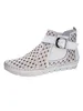 A white bootie with a perforated pattern and a buckle strap. Produktbild-Vorschau