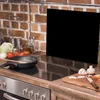 A kitchen scene with a stovetop, cooking utensils, and ingredients. Anteprima dell’immagine prodotto