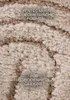 Close-up of a textured rug with text overlays. Anteprima dell’immagine prodotto