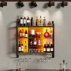 A wall-mounted wine rack filled with bottles and glasses, illuminated by LED lights. Produktbild-Vorschau
