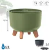 A green planter with wooden legs is shown with dimensions and other product details. Smaller images of other product variations are also visible. Náhled obrázku produktu