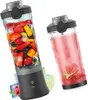 Two portable blenders are shown, one filled with fruit and ice, the other with a pink smoothie. Ice cubes, raspberries, and a lime slice are scattered around the blenders. Voir les images du produit