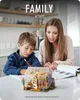 A mother and son are working on a miniature house kit together at a table. Podgląd zdjęcia produktu