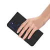 A hand holding a black phone case. Podgląd zdjęcia produktu