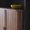 A close-up view of a wooden cabinet with a decorative bowl on top. Produktbild-Vorschau