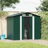 A green metal garden shed is shown outdoors on a paved area, with grass and foliage in the background. Podgląd zdjęcia produktu