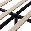 A close-up view of the wooden slats and black metal frame of a bed base. Náhled obrázku produktu