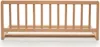 A wooden bed guard rail is shown against a white background. Voir les images du produit