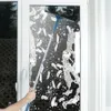 A person is cleaning a window with a squeegee on an extension pole. Podgląd zdjęcia produktu