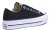 A black Converse sneaker with a white platform sole is shown from the side against a white background. Voir les images du produit