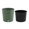 A green planter and a black insert are shown side-by-side on a white background. Produktbild-Vorschau