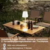A table lamp on a wooden table outdoors, with chairs and bottles of drink. Náhľad obrázku produktu