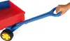 A hand is holding the handle of a red and blue toy wagon. Produktbild-Vorschau