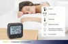 A woman sleeping in bed next to a digital alarm clock. Anteprima dell’immagine prodotto