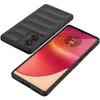 A black phone case is shown next to a smartphone with a red and orange wallpaper. Náhled obrázku produktu
