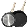 Two black frying pans with wooden handles are shown against a white background. One pan is shown from the underside, revealing a silver metallic base with a circular pattern. The other pan is shown from the top, revealing its interior. Náhľad obrázku produktu