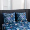 Two pillows with a floral and bird pattern are placed on a bed with a matching duvet cover. Náhled obrázku produktu