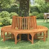 A wooden bench is placed around a tree in a garden. Anteprima dell’immagine prodotto