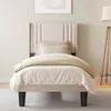 A bedroom scene with a bed and a floor lamp. Podgląd zdjęcia produktu