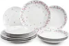 A collection of white ceramic plates and bowls with a floral pattern. Produktbild-Vorschau