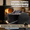 An ash bucket filled with ash, with a fireplace in the background. Produktbild-Vorschau