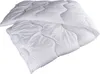 A white quilted comforter is folded and lying on a white surface. Produktbild-Vorschau