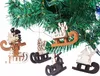 Christmas tree ornaments in the shape of wooden sleds with various figures on them, hanging from a Christmas tree branch. Náhľad obrázku produktu