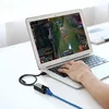 A person is using a laptop, with a network adapter connected to it and an Ethernet cable plugged into the adapter. Voir les images du produit