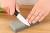 Hands sharpening a knife on a sharpening stone. Produktbild-Vorschau