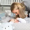 A mother is interacting with her baby in a baby lounge. Anteprima dell’immagine prodotto