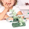 A young child is playing with a dinosaur-themed toy slide. Náhled obrázku produktu