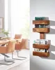 A wooden wall shelf with books and magazines, next to a dining table with chairs. Produktbild-Vorschau