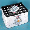 A beer crate decorated with a Christmas theme, featuring Santa Claus and snowflakes, with advent calendar stickers on top of the bottles. Produktbild-Vorschau