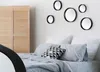 A bedroom scene with a bed and mirrors on the wall. Produktbild-Vorschau