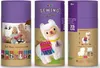 The image shows the packaging for a sewing kit for a llama toy. The packaging is a cylindrical tube with graphics depicting the finished product, children sewing, and other sewing kits. Náhled obrázku produktu