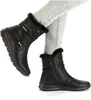 A pair of black women's boots worn with light grey jeans. Anteprima dell’immagine prodotto