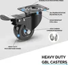 A close-up view of a black heavy-duty caster wheel with labels pointing to its different components and features. Two ball bearings are shown separately on the right side. Voir les images du produit