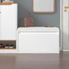 A white storage bench with a drawer, a handbag, and a mirror in the background. Produktbild-Vorschau