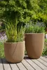 Two planters with plants on a wooden deck in a garden. Náhľad obrázku produktu