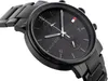 A close-up, angled shot of a black Tommy Hilfiger watch. Náhled obrázku produktu
