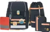 A set of dark blue school bags and accessories with orange accents, displayed against a white background. Voir les images du produit