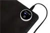 A close-up of a heated desk mat with a control unit showing a timer and power button. Produktbild-Vorschau