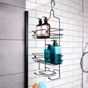 A black metal shower caddy hanging on a tiled wall, filled with various bottles of toiletries and a bar of soap. Anteprima dell’immagine prodotto
